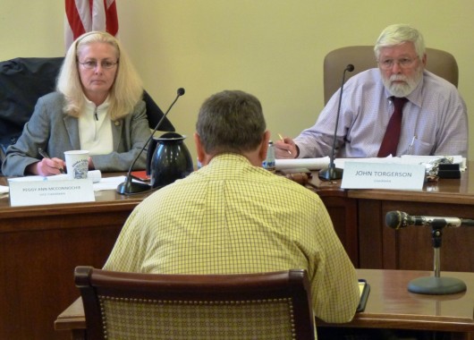 7-2-13 Compressed Alaska Redistricting Board Chairman Jogn Torgerson and member Peggy Ann McConnache listen as Dennis DeWitt spreaks during a Juneau public hearing.