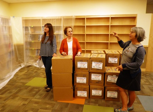 8-13-13 Barb Steltz, right, talks about a squid painting planned for above library shelves while library board member Anne Hurt and Borough Librarian Tara Alcock consider the space.