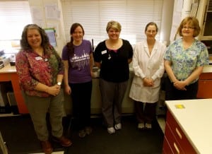 (From left) Liz Bacom, Jessica Fetters, Laurie Miller, Nancy Higgins, and Cindy Fisher stand in front of the "Siemens Dimension Chemistry Analyser" screening machine in the Petersburg Medical Center. Photo/Angela Denning
