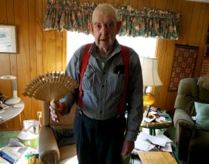 Tom Lewis holds a dance fan he whittled from a single piece of wood. Photo/Angela Denning