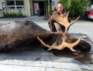 Peter Baekkelund of Petersburg poses with his moose which was the first kill reported this season. It was taken at Falls Creek on Mitkof Island. Photo/ADF&G