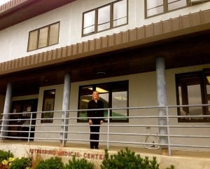CEO, Liz Woodyard, stands under the new roof at the Petersburg Medical Center. Photo/Angela Denning