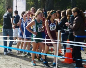 Members of high school cross-country girls' teams line up just past the finish line during Saturday's meet.