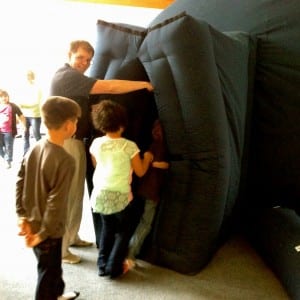 UAF Professor Robby Herrick helps Petersburg students enter the planetarium. Photo/Angela Denning