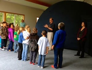 UAF Professor, Robby Herrick and Postdoctoral fellow, Emma Marcucci, address a 2nd grade class before the students enter the planetarium. Photo/Angela Denning