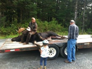 Peter Baekkelund of Petersburg sits on his moose which was the first kill reported this season. It was taken at Falls Creek on Mitkof Island. Photo courtesy of Peter Baekkelund.