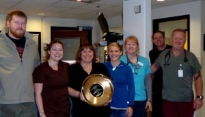 PMC nursing staff pose with the gold pan award. Pictured from left to right: Brian Oakes, Mamie Nilsen, Tamara McKeown, Helen Boggs, Christina Axmaker, Larry Welk, Rick Griffin. Photo/ courtesy of PMC