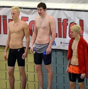 Abel Aulbach stands on the podium after taking first and breaking the state record in the 100 yard freestyle. Photo/Doug Fleming