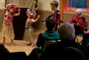 Hula dancers and musicians perform, "Mele Kalikimaka" at the Holiday Literary. From left: Kate Thompson, Anna Baekkelund, Jonas Baekkelund and Sally Reimer.