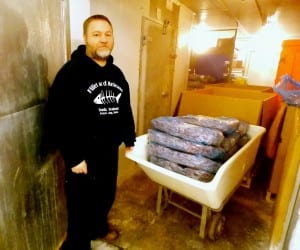 Seth Scrimsher stands in one of Tonka's freezers with blocks of frozen pink shrimp. Photo/Angela Denning