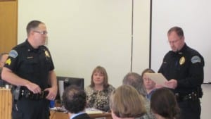 Sergeant Jim Kerr, left, is honored for two life saving efforts by Petersburg Police Chief Kelly Swihart.