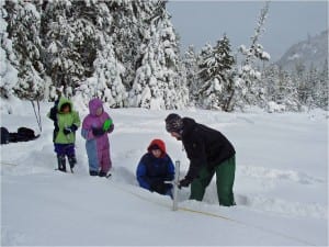 Heath Whitacre, hydrologist with the Forest Service in Petersburg, leads girl scouts in measuring the snow pack in a snowy year. Photo courtesy of Heath Whitacre