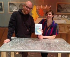 Orin Pierson and Mary Koppes stand on stage with the program for their musical, "Shipwreck on Cannery Island." Photo/Angela Denning