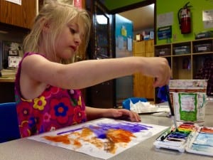 5-year-old Arielle Tucker paints in the Rainbow classroom. Photo/Angela Denning