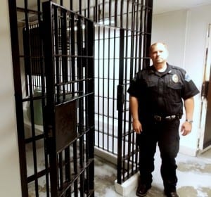 Kelly Swihart, Petersburg's Chief of Police, stands in front of one of the cells in the community jail. (Joe Sykes)