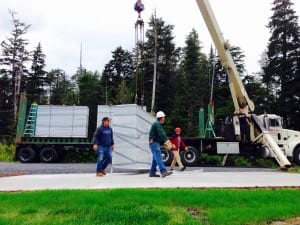 The first columbarium gets hoisted off the truck at the cemetery, Aug. 10. Photo/Angela Denning