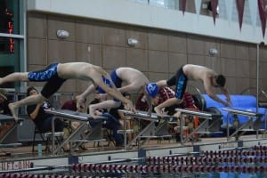 Left to right: Ben From left to right, Petersburg swimmers Ben Higgins, Van Abbott, and Casey Evens push off the starting blocks at the Ketchikan meet. Photo/Brad Taylor 