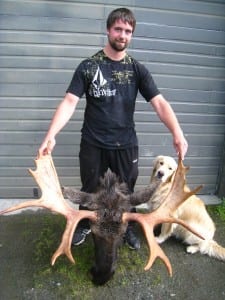 Petersburg resident, Darren Lachapelle, holds the antlers of a moose he killed this season. Photo courtesy of Rich Lowell/ADF&G