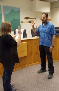 Borough clerk Debbie Thompson swears in new assembly member Eric Castro Friday morning.