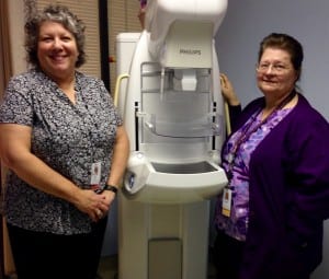 Liz Bacom and Renee Hertless stand with Petersburg Medical Center's new mammography machine. Photo/Angela Denning