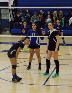 Emma Chase and Adanna Kvernvik await a serve during a match against Metlakatla Friday.