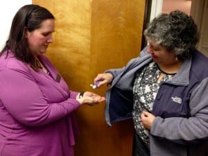 Liz Bacom with the Petersburg Medical Center shares hand sanitizer with Erin Michael, Public Health Nurse. Photo/Angela Denning