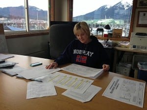 Petersburg Harbor Master Glorianne Wollen looks over the 95 percent design plan of the proposed bulkhead loading dock. Photo/Angela Denning
