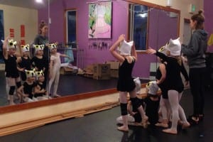 First graders in Kathleen Boggs' Ballet One class check out their snow owl hats at the dance studio. Photo/Angela Denning