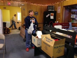 Robin Roberts looks through supplies while volunteering at the Sons of Norway hall. Photo/Angela Denning