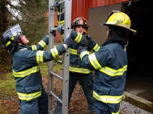 Lloyd Rice gets instructed by Dan Bird while Annette Wooton helps hold the ladder. Photo/Angela Denning