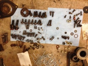 Bolts, washers and other parts are organized on a work table in the Scow Bay Fire Hall. Photo/Angela Denning