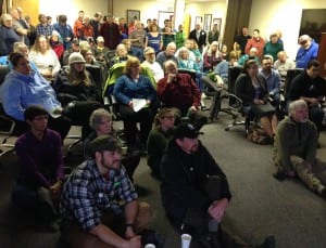 Petersburg caucus goers watch videos of the three Democratic candidates running for President. Photo/Angela Denning
