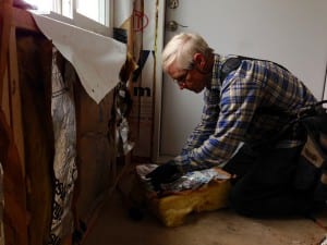 Jim Schwartz adds insulation to the walls of the Petersburg Children's Center. Photo/Angela Denning