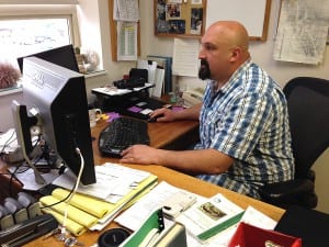 ADF&G Area Management Biologist, Troy Thynes, looks at historical run data of Stikine River kings in his Petersburg office. Photo/Angela Denning