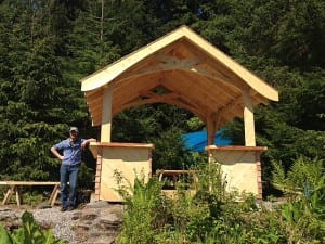 Michael Truex stands next to the Kupreanof shelter he built with locally milled wood. The shelter is near the Kupreanof dock. Photo/Angela Denning