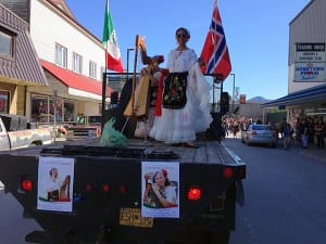 Cristina Cabrera plays the harp and her aunt, Evelyn, dances on a flatbed truck in the parade. Photo/Angela Denning