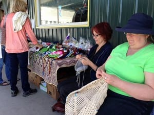 Jeane Osborne and Gladys Carter crochet at a booth in downtown Petersburg. Photo/Angela Denning