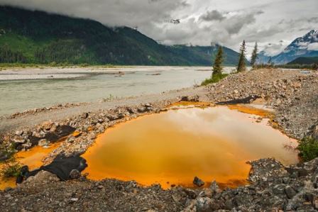 Acid drainage from the Tulsequah Chief Mine discolors a leaking containment pond next to the Tulsequah River in British Columbia in 2013. Developer Chieftain Metals is in receivership. (Photo courtesy Chris Miller/Trout Unlimited)