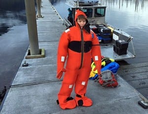 Elliot Nash, age 12, tries on a survival suit at the South Harbor in Petersburg. Photo/Jonathan Nash