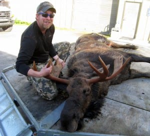 Joe Willis of Petersburg sits with the legal moose he caught in the local moose hunt. Photo courtesy of ADF&G