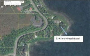 The borough lot for sale is on the curve of the beach leading to Sandy Beach. 