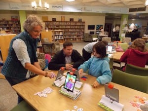 School board member, Jay Lister, gets a lesson on OSMO from student Maria Toth while Stedman librarian, Mary Ellen Anderson checks out another program. Photo/Angela Denning