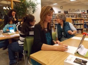 Superintendent, Erica Kludt-Painter, tries out a drawing program on OSMO while school board members Mara Lutomski and Cheryl File check out programs at the other table. Photo/Angela Denning