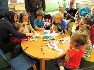 Young children make art at the public library during an open play program. Photo courtesy of Petersburg Public Library