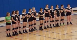 From left, Martha Johnson, Kaitlin Willis, Katie Brock, Kaia Dahl, Chandler Strickland, Courtney Fredricksen, Emma Chase, Tanya Spears, Hana Newman, Elisa Larson, Abi Bennett and Kallie Caples line up before Friday's match with Wrangell.