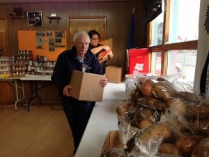 Volunteers Steve Homer and Mysti Birks pack Thanksgiving boxes for the Salvation Army Church. Photo/Angela Denning