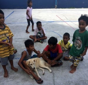 Children wait for their dog to be seen at a MIOAW clinic. Photo courtesy of Lora Lee Mason