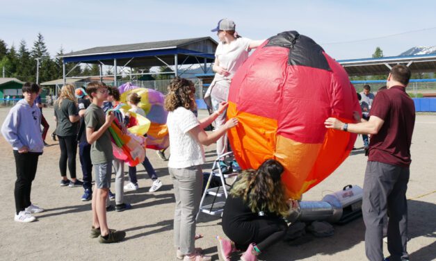 Middle school students release balloons at school year’s end