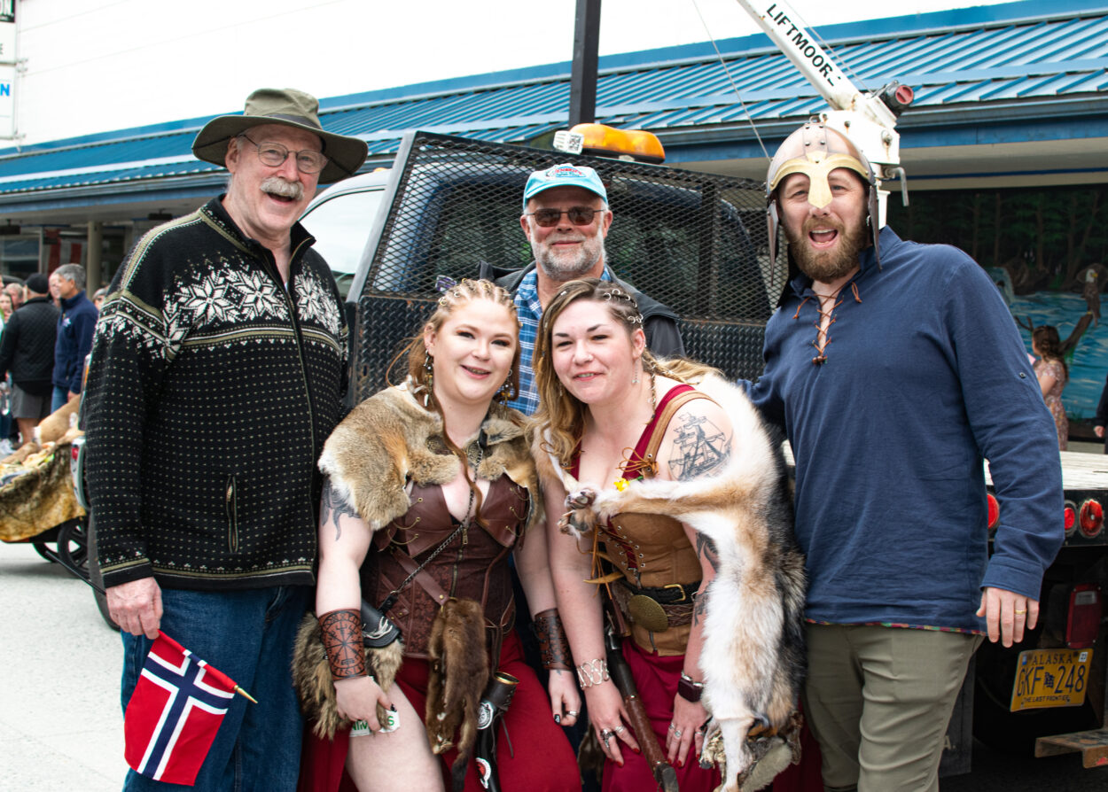 Bert Stedman, Mark Jensen, and Josh Reback pose with two valkyries in front of a truck bed.